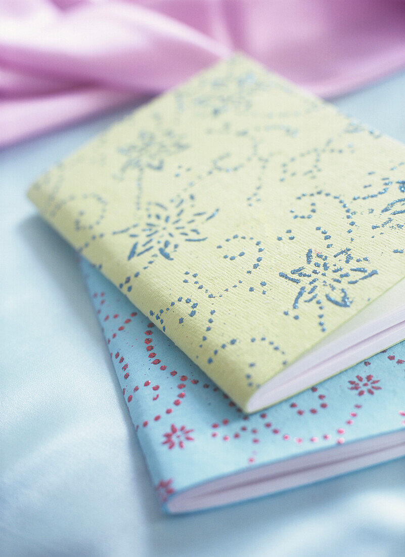 Two colourful notebooks