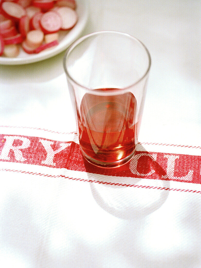 Glass of red wine and cut radishes Spain