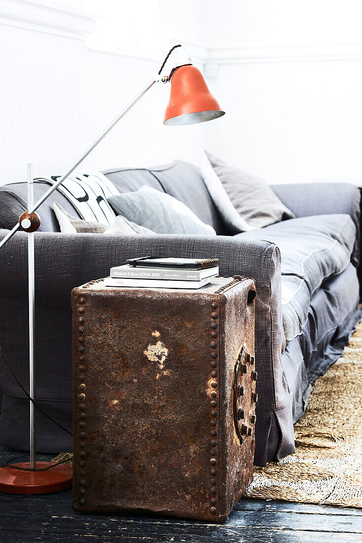 Rusty metal case with vintage floor lamp and sofa in Lyme Regis home Dorset UK