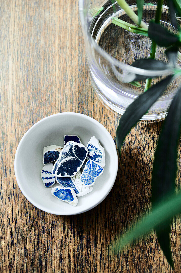 Fragments of broken ceramics in bowl Lyme Regis home Dorset UK