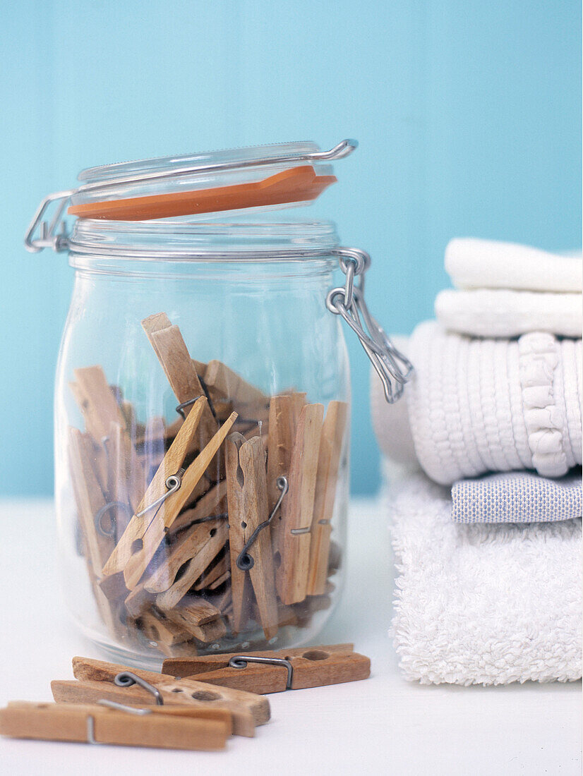 Wooden clothes peg storage jar and towels