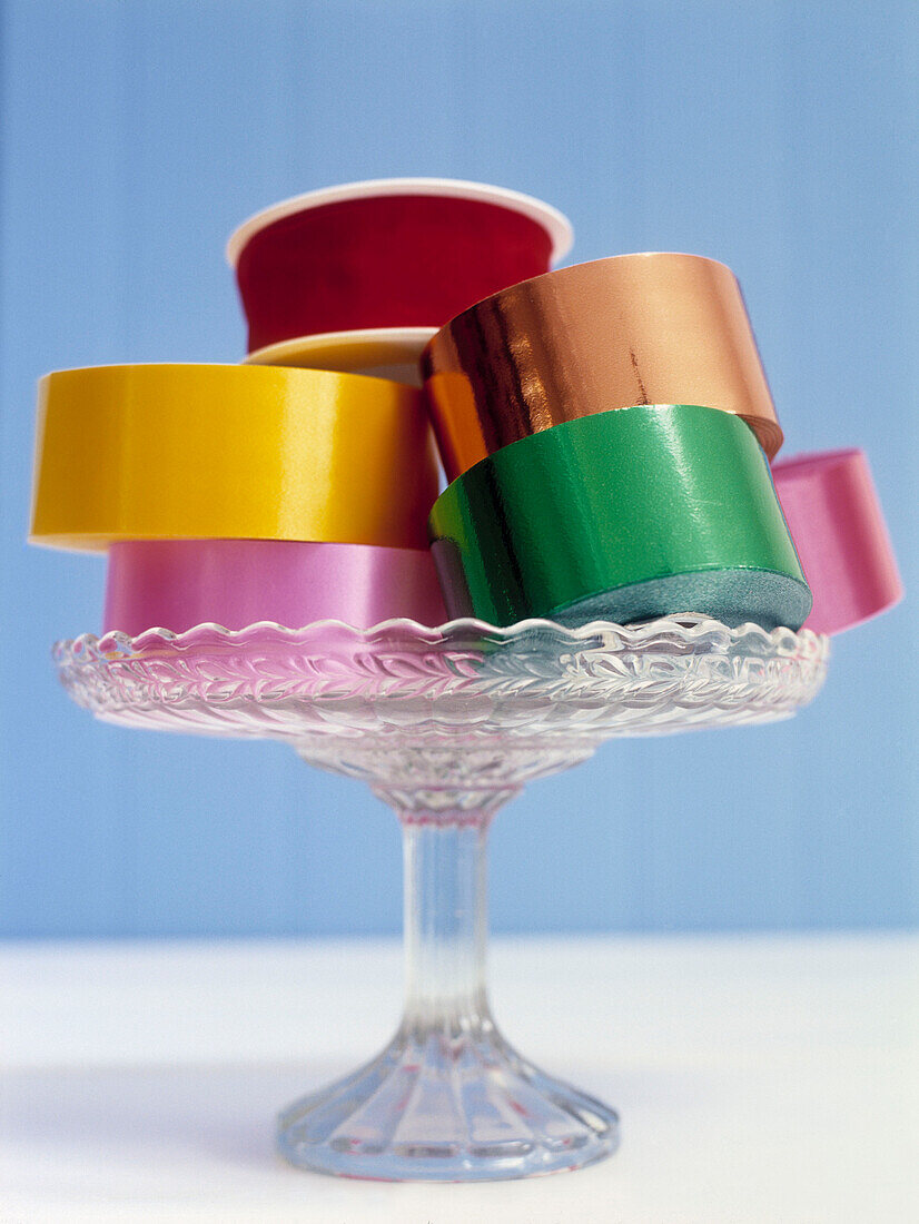 Assorted ribbons on glass cake stand