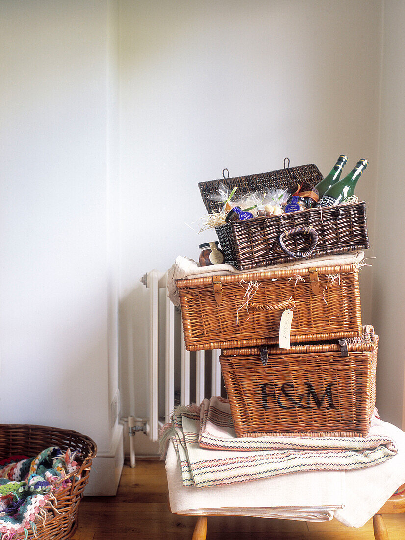 Open hamper with bottles stacked on top of folded linen