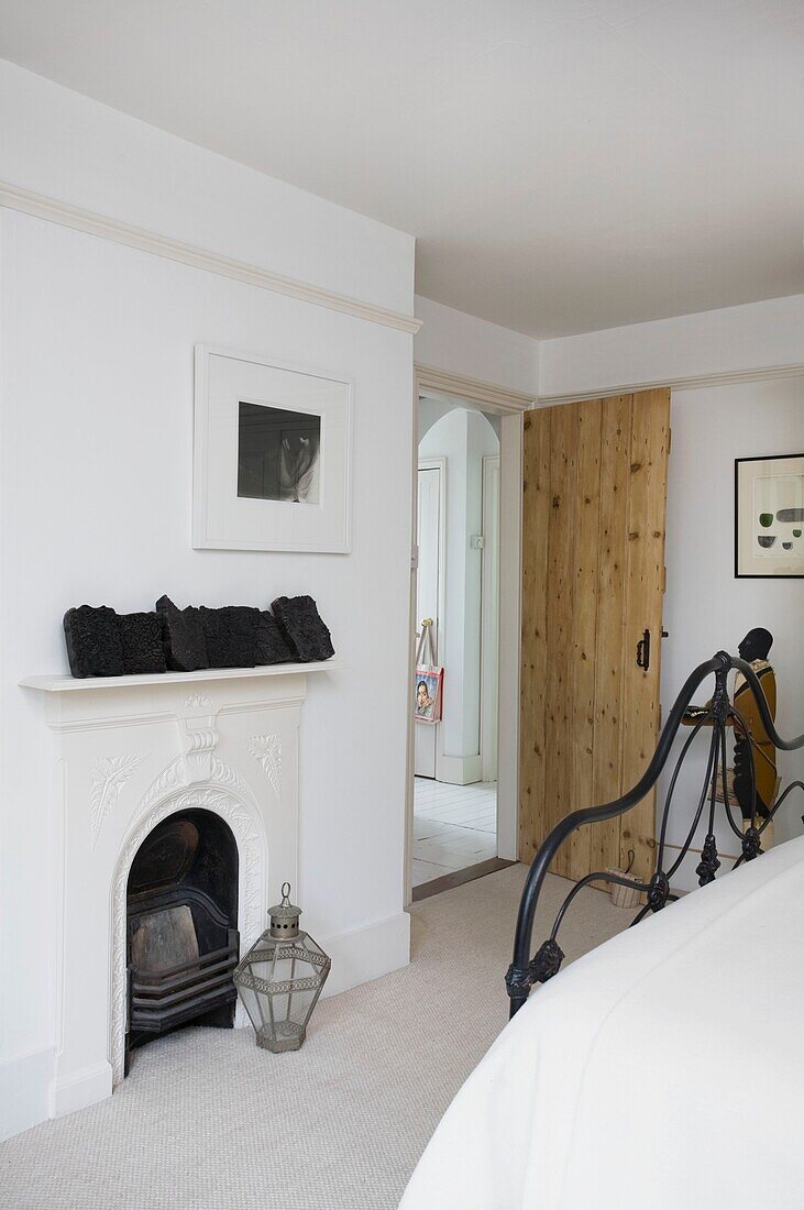 Metal lantern at original fireplace in bedroom of Tenterden home, Kent, England, UK