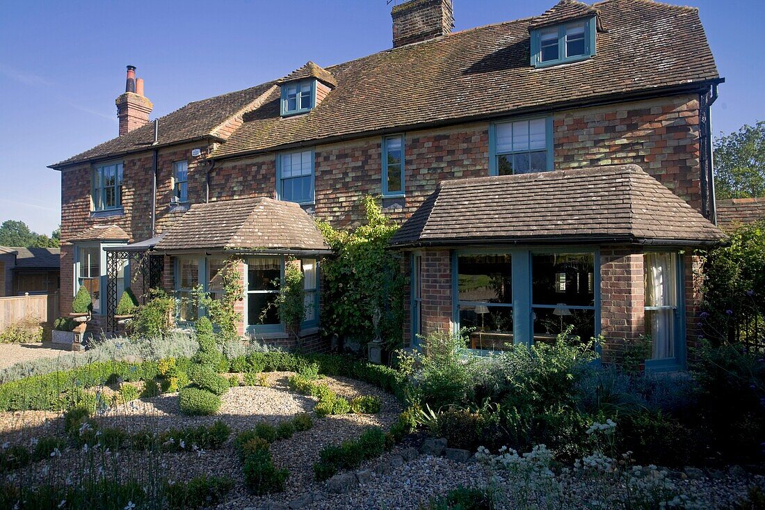 Sunlit exterior of detached house in Grafty Green, Kent, England, UK