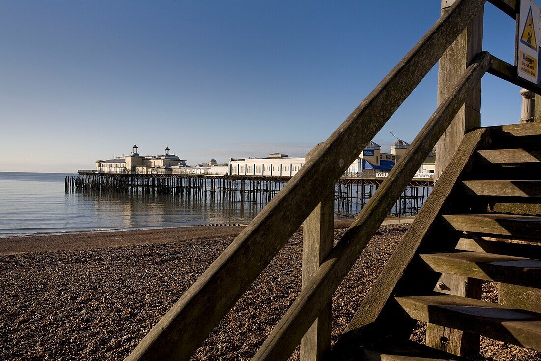 View of pier and wooden steps at shingle beach of St Leonards on Sea, East Sussex, England, UK