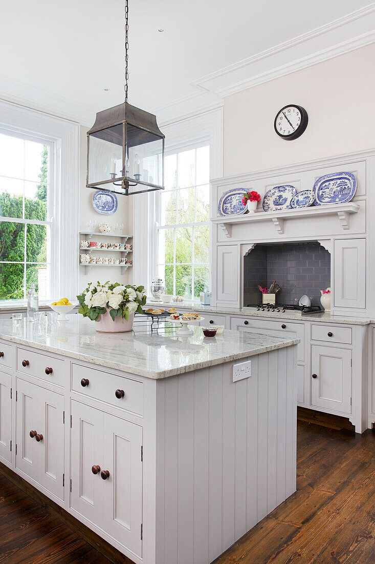 Metal lantern above marble topped kitchen island in Kilndown home Cranbrook Kent England UK