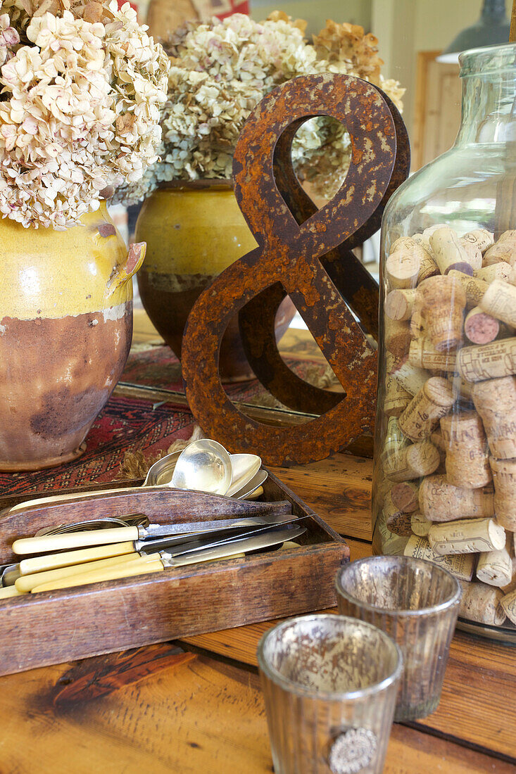 Dried hydrangea with rusty ampersand and wine corks in Kent home England UK