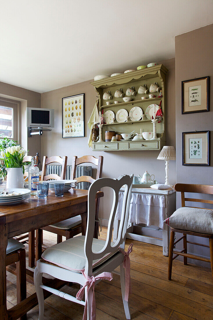 Wall mounted shelving storage in dining room of Victorian villa Kent England UK