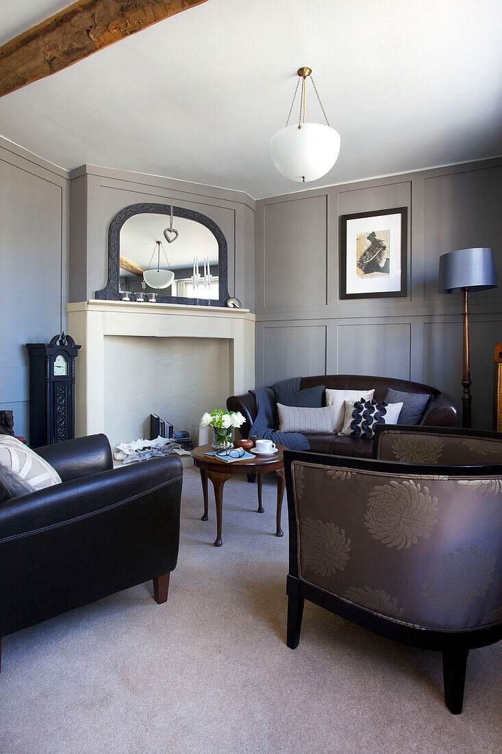 Seating area with mirror on fireplace in Old Town townhouse Portsmouth England UK