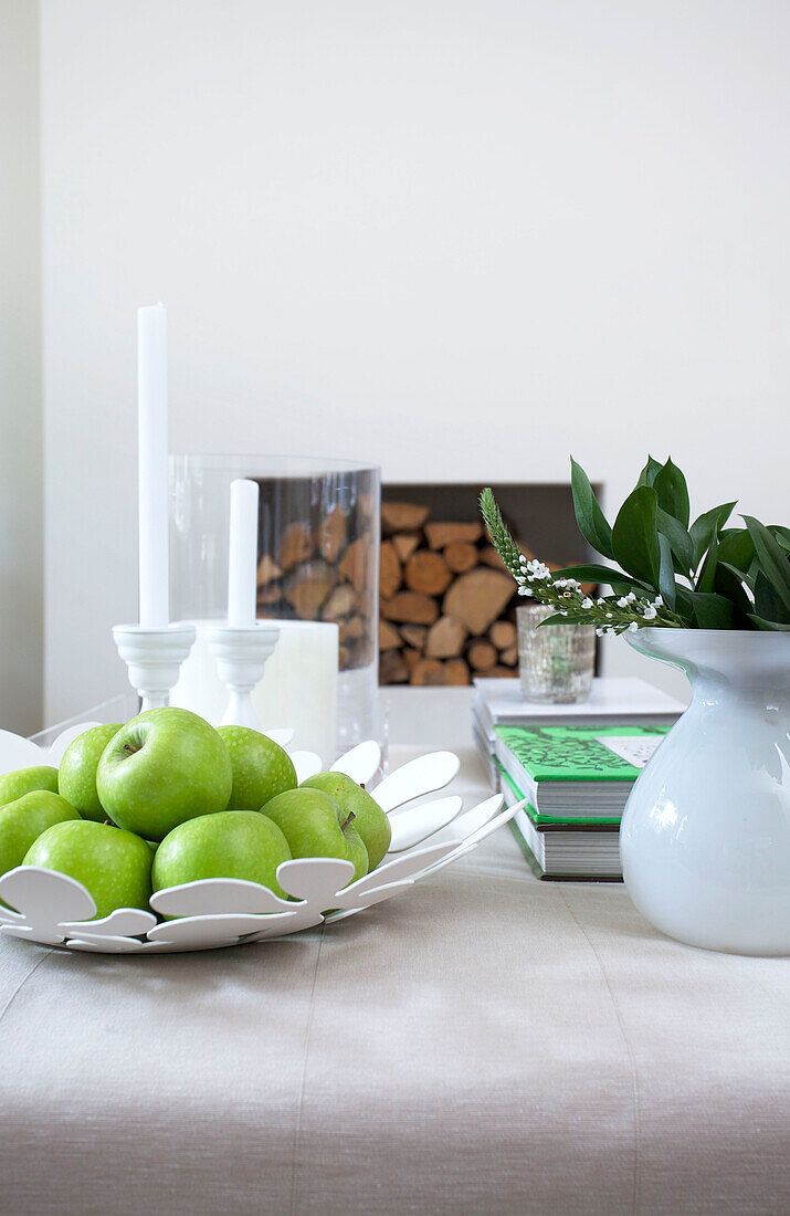 Fresh apples on table with leaf arrangement in Wandsworth home London England UK