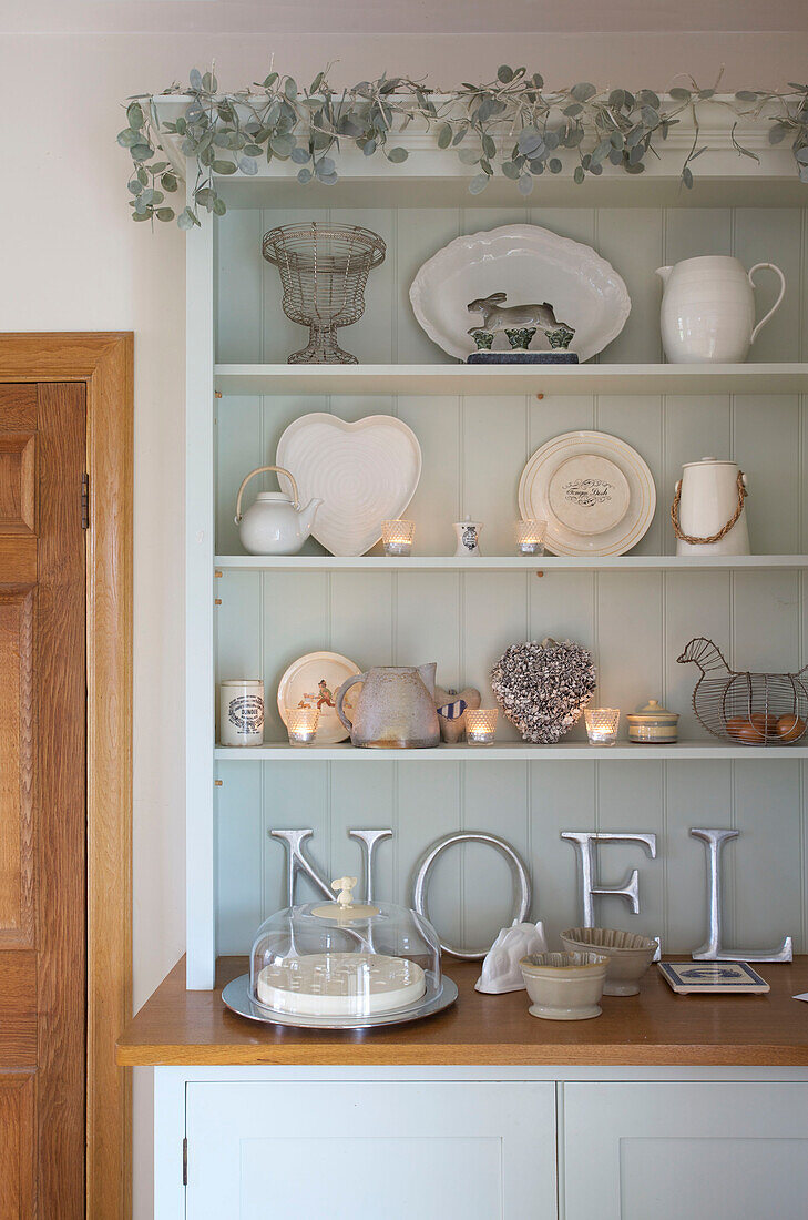 Cream kitchenware on painted kitchen dresser in Faversham home Kent England UK