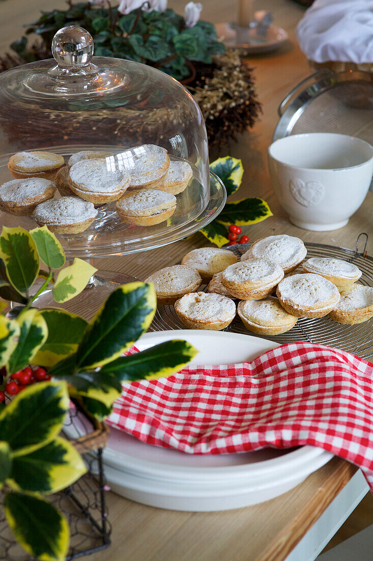 Mince pies on cake stand with gingham dishcloth on Faversham kitchen table Kent England UK