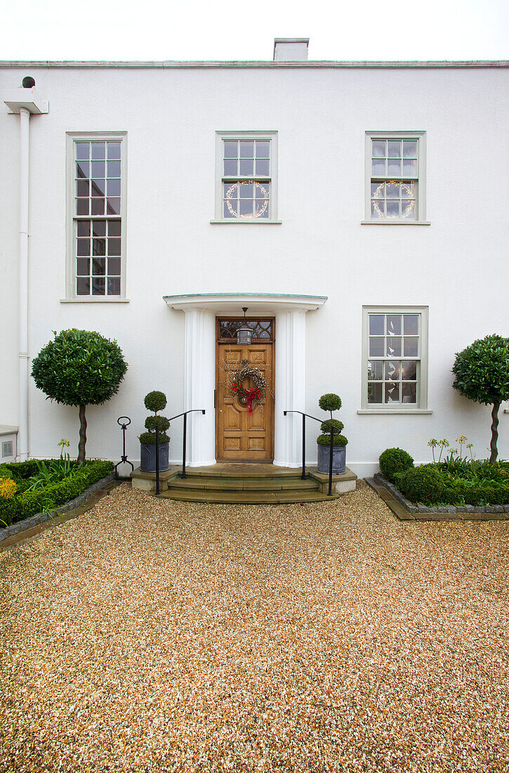 Whitewashed facade with gravel driveway Faversham home Kent England UK