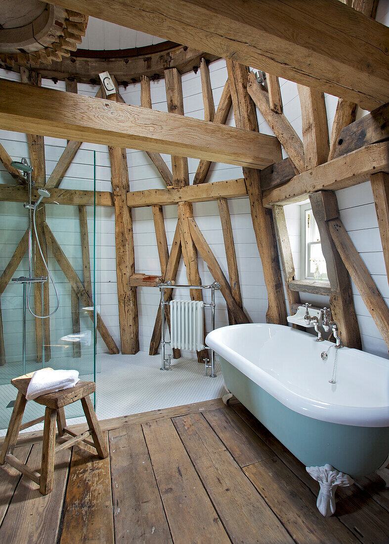 Freestanding bath and walk in shower on 'dust floor' of Grade ll listed windmill conversion Kent UK