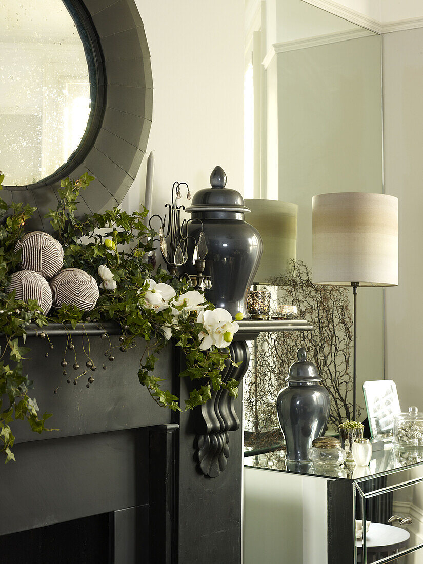 Floral Christmas garland on mantlepiece with mirror in London home England UK