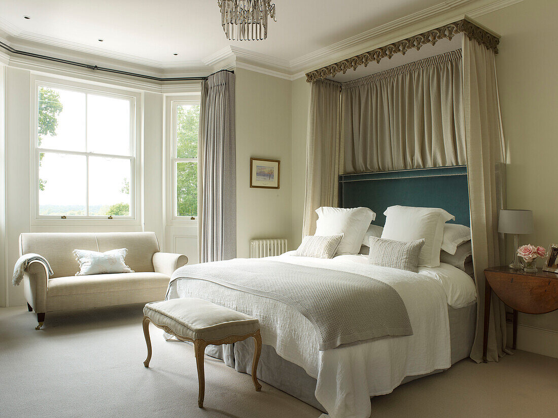 Cream sofa at bedroom window in classic East Sussex country house England UK