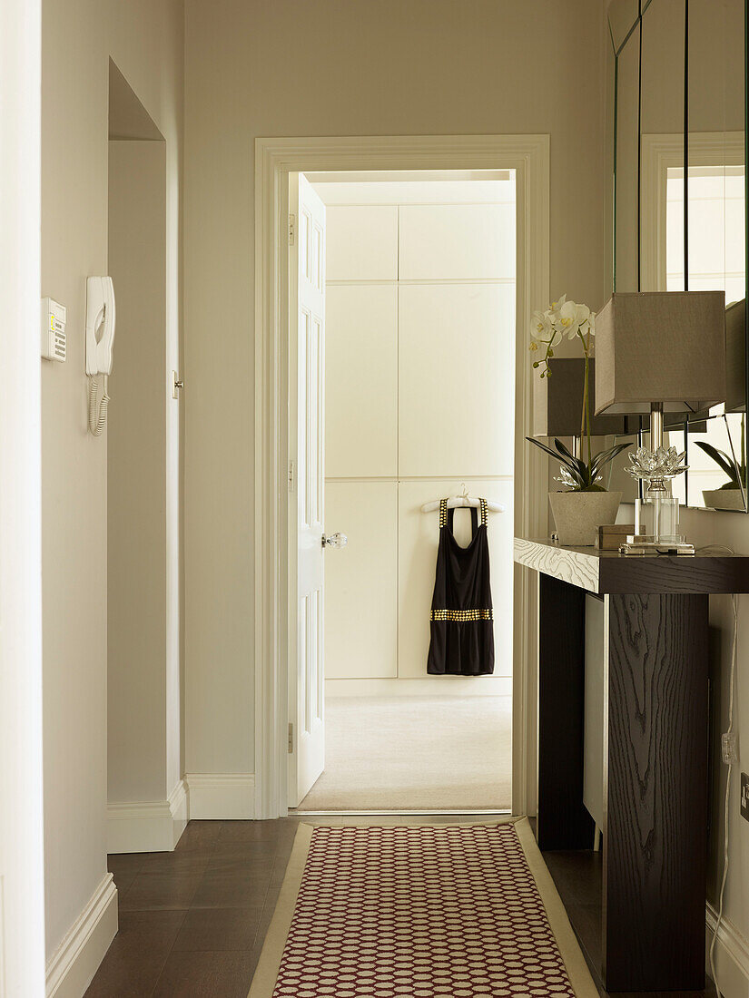 Patterned rug in hallway with view through doorway in Little Venice townhouse London England UK