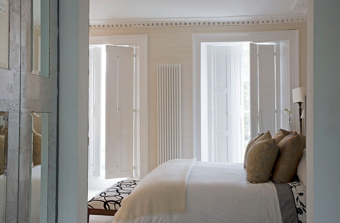 View through doorway to bedroom of London home UK