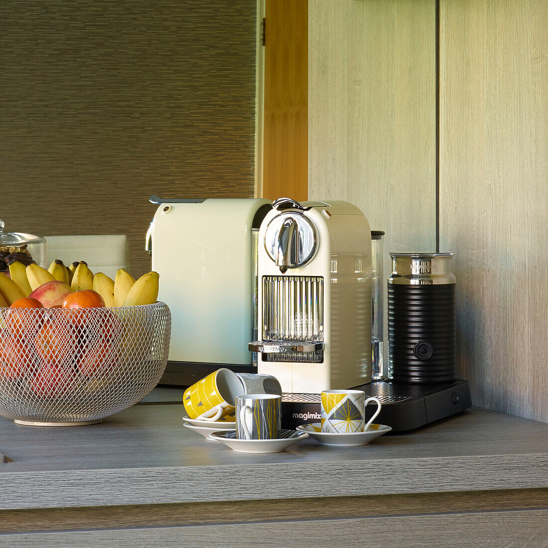 Fruit bowl and coffee machine with retro style vintage cups in Manchester kitchen, England, UK