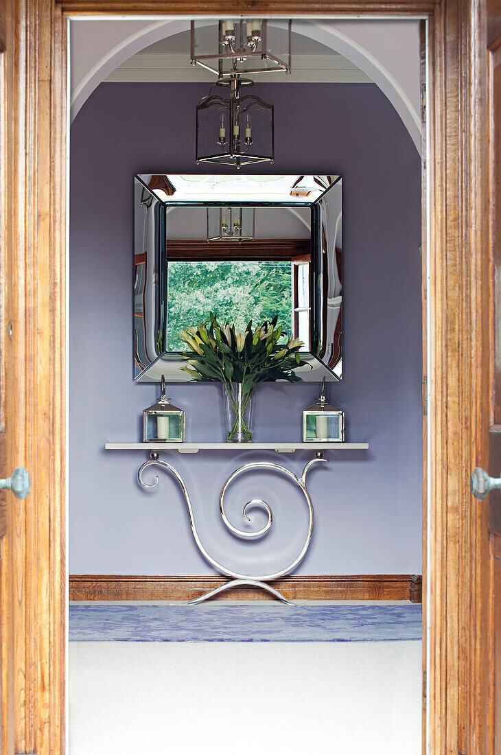 View through doorway to console table and mirror in Suffolk home UK