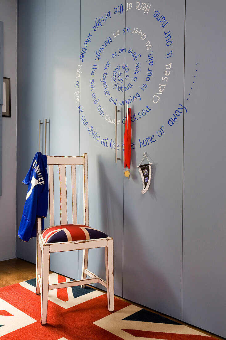 Football shirt on chair with Union Jack in boy's room London UK