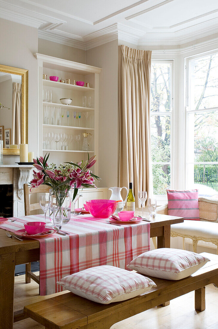 Pink homeware on table in London dining room UK