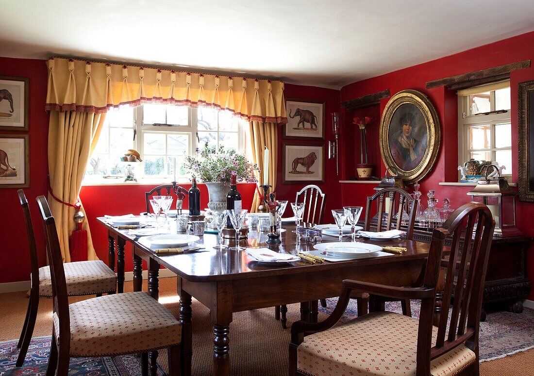 Wooden dining table and chairs in Kent dining room England, UK