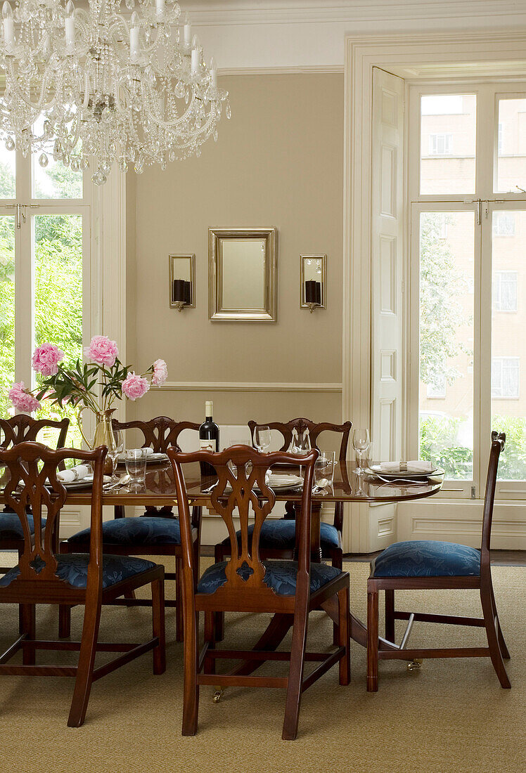 Chandelier above set dining table in London townhouse