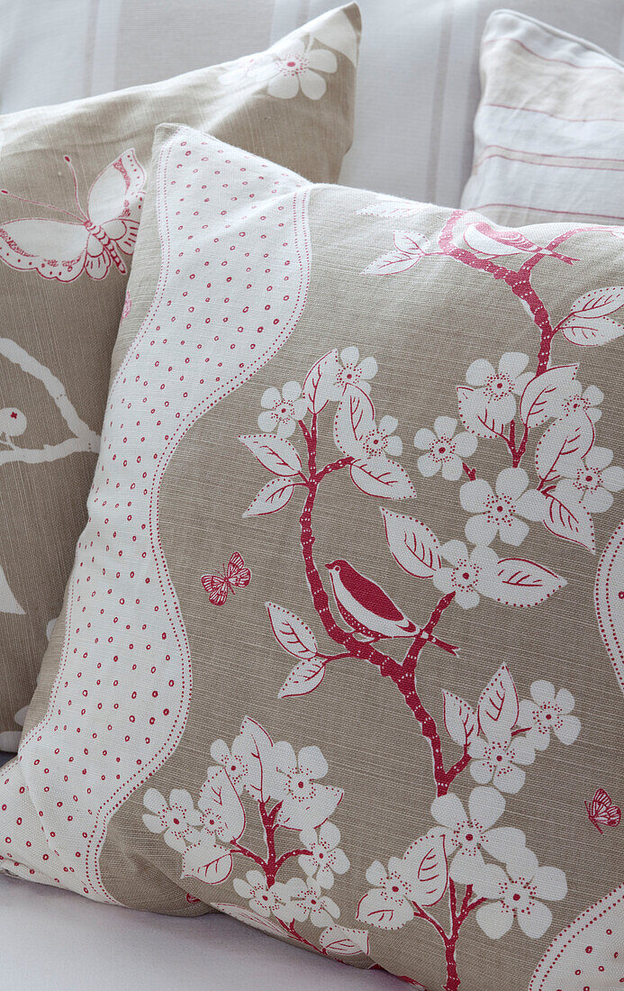 Floral patterned cushions with butterflies and birds in Surrey home, England, UK