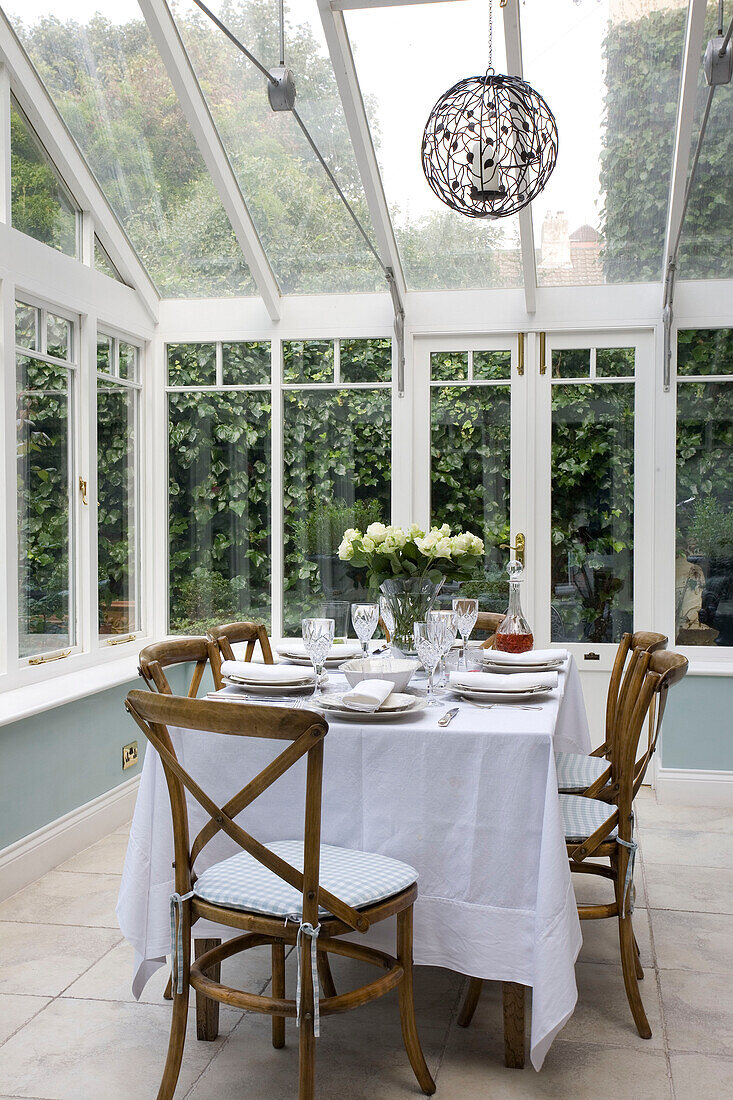 Table for six in conservatory extension of classic Tyne & Wear home, England, UK