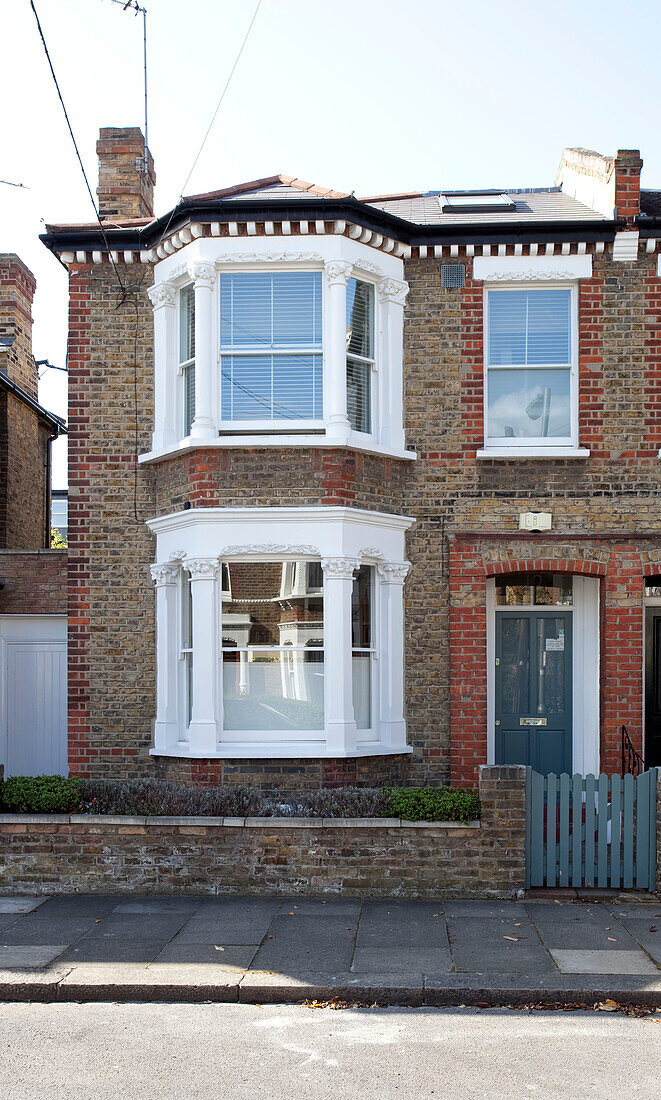 Semi-detached London house in sunlit street, UK