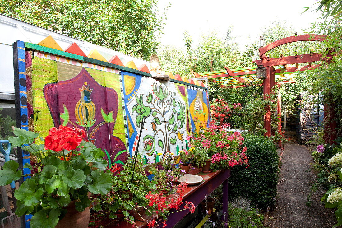 Handpainted artwork and pergola in garden of London home England UK