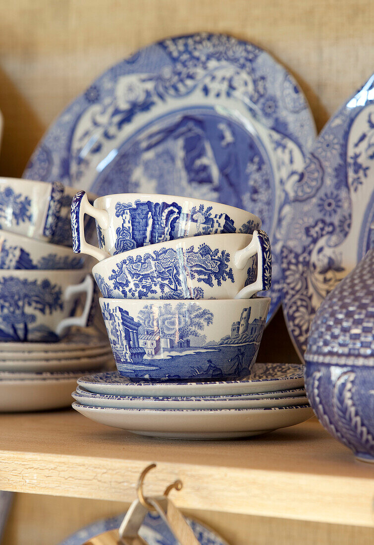 Blue and white chinaware on shelf of kitchen dresser in Kent farmhouse England UK