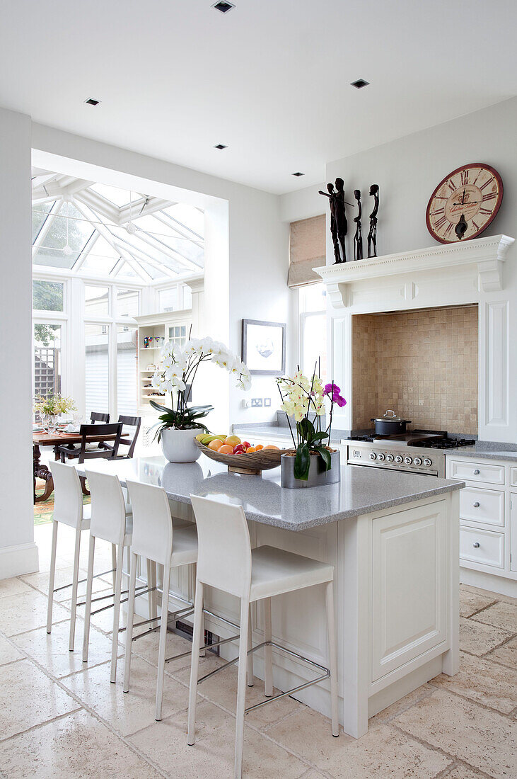 Marble breakfast bar in contemporary kitchen with extension in London family home, UK