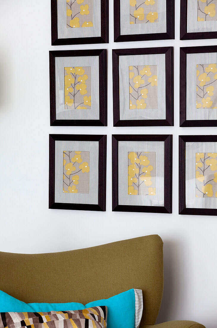 Floral artwork and vintage chair in living room of contemporary Surrey country home England UK