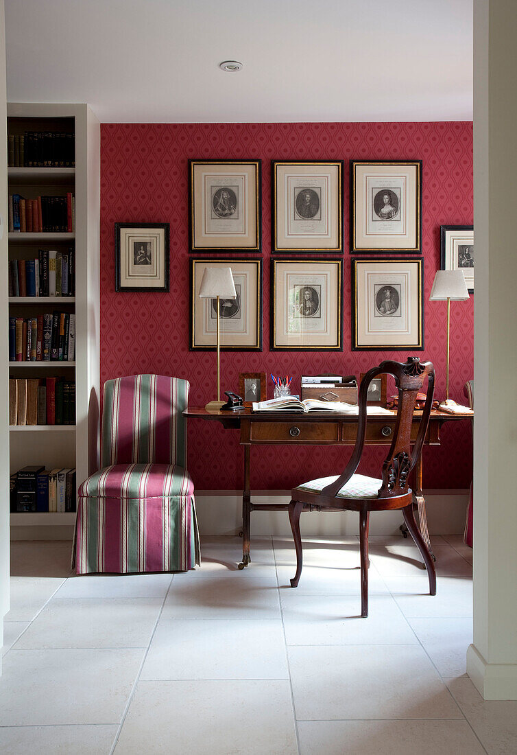 Polished wood desk and chair in study of Sussex farmhouse, England, UK