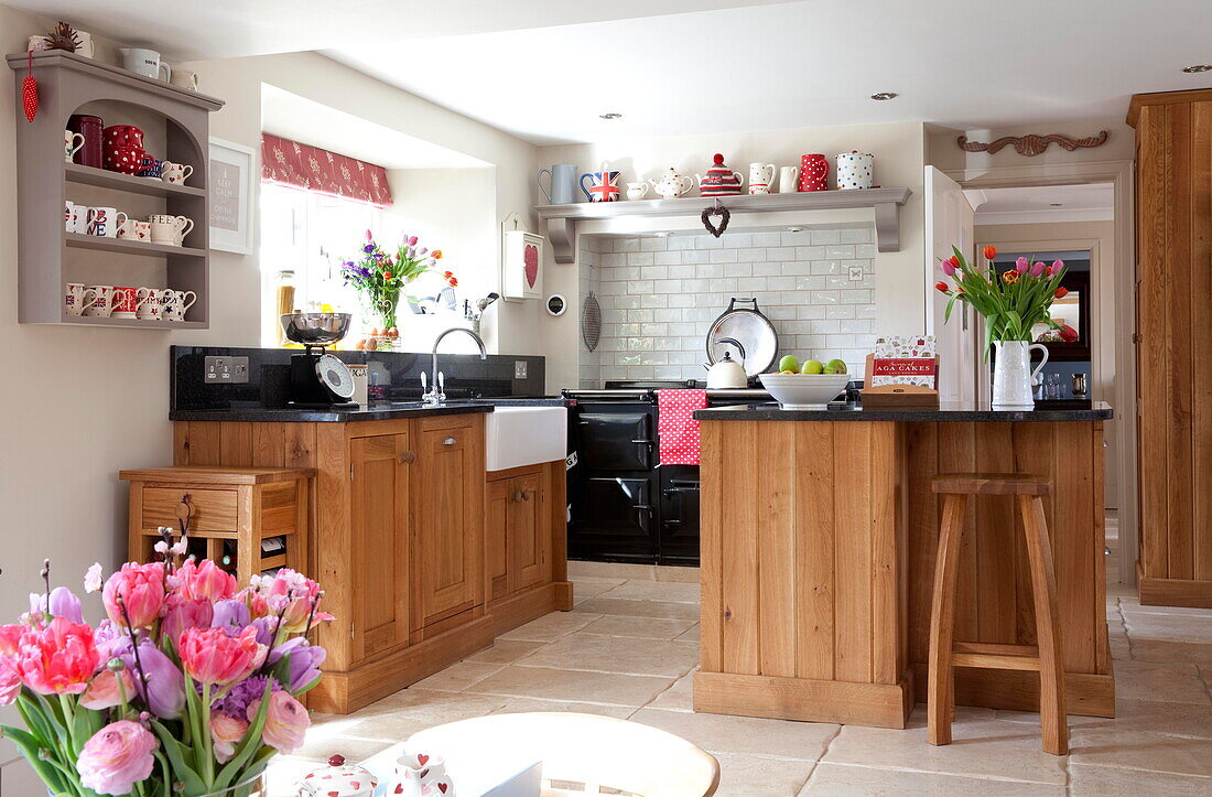 Wood fitted kitchen with wall mounted shelf in Staffordshire farmhouse kitchen England UK