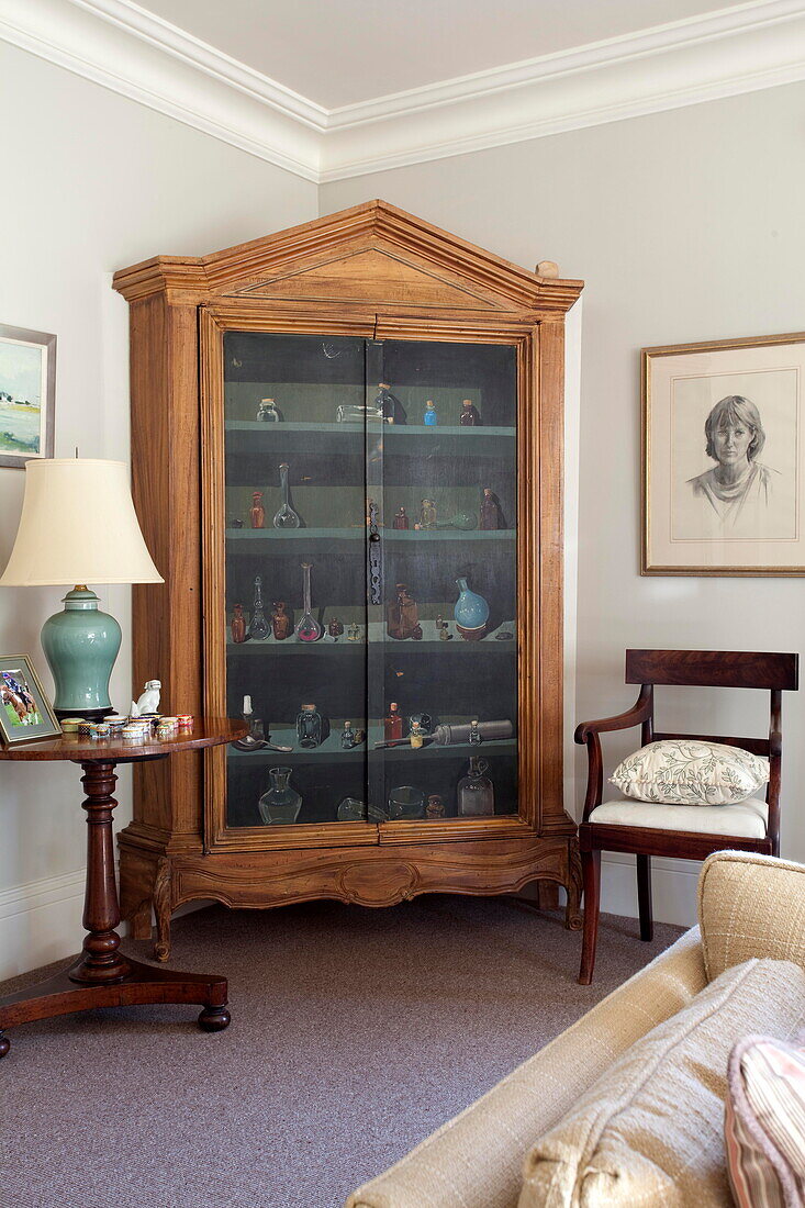 Antique wooden drinks cabinet with side table and chair in Kent home England UK