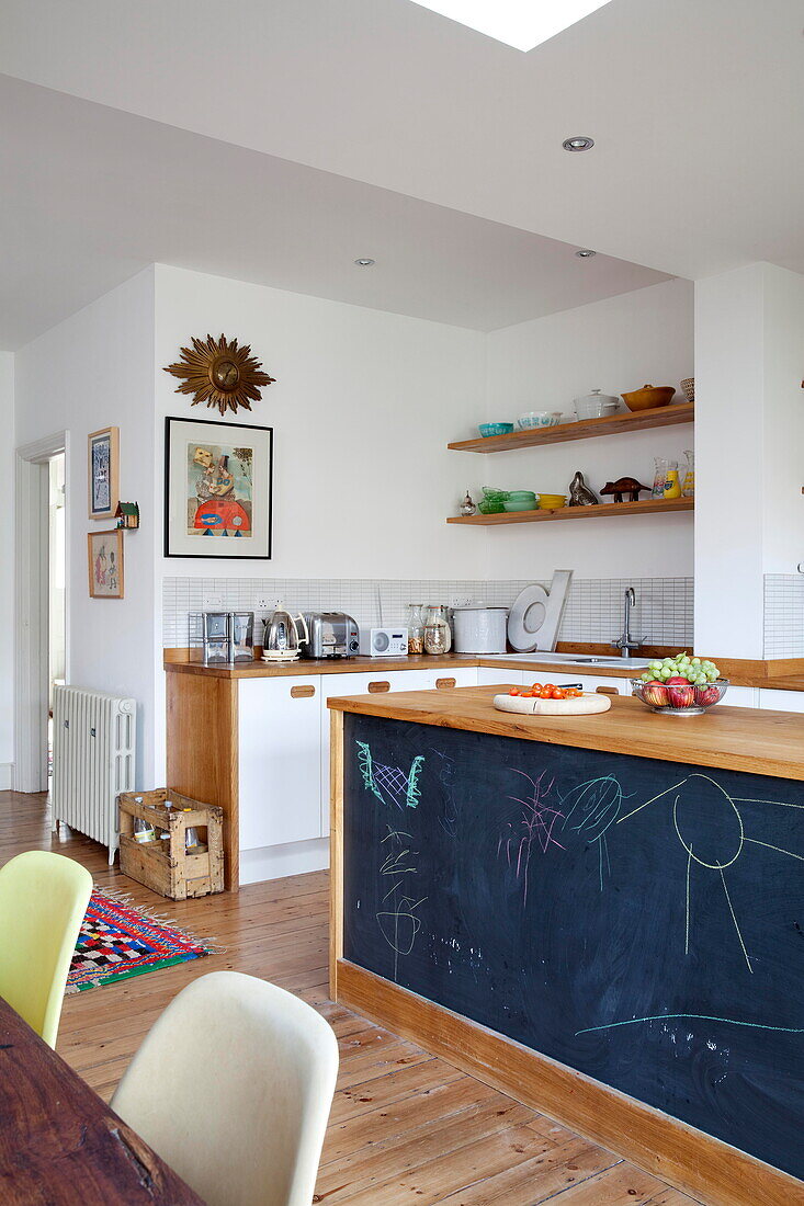 Blackboard space on side of kitchen island in Kent family home England UK