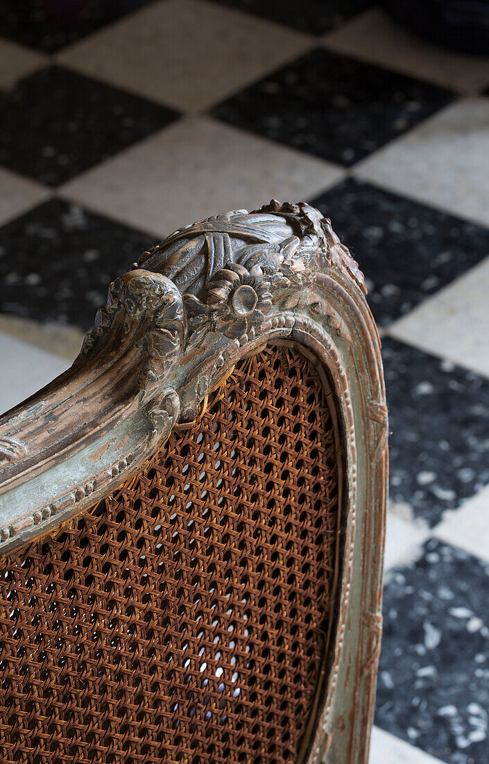 Carved wicker antique chair back in country house in the Loire France Europe