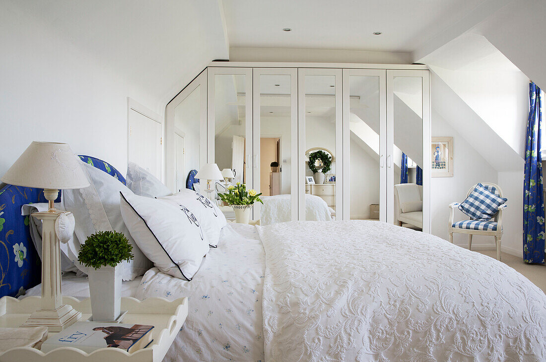 Mirrored wardrobe in bedroom with co-ordinating fabrics, West Mailing home, Kent, England, UK