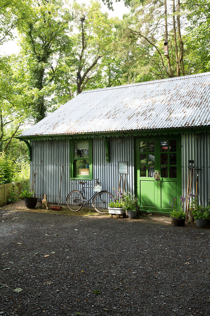 Tarmac driveway in front of corrugated metal shed Ceredigion Wales UK