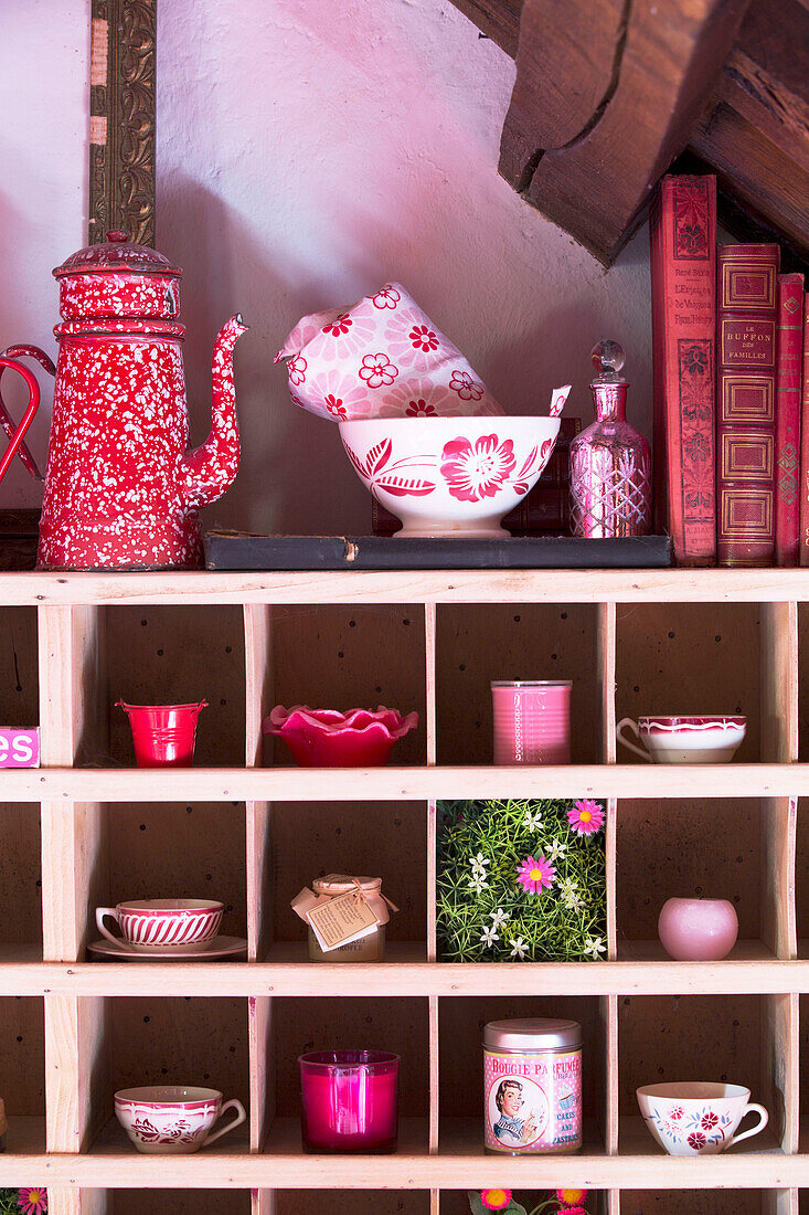 Homeware and books on storage shelves in French farmhouse