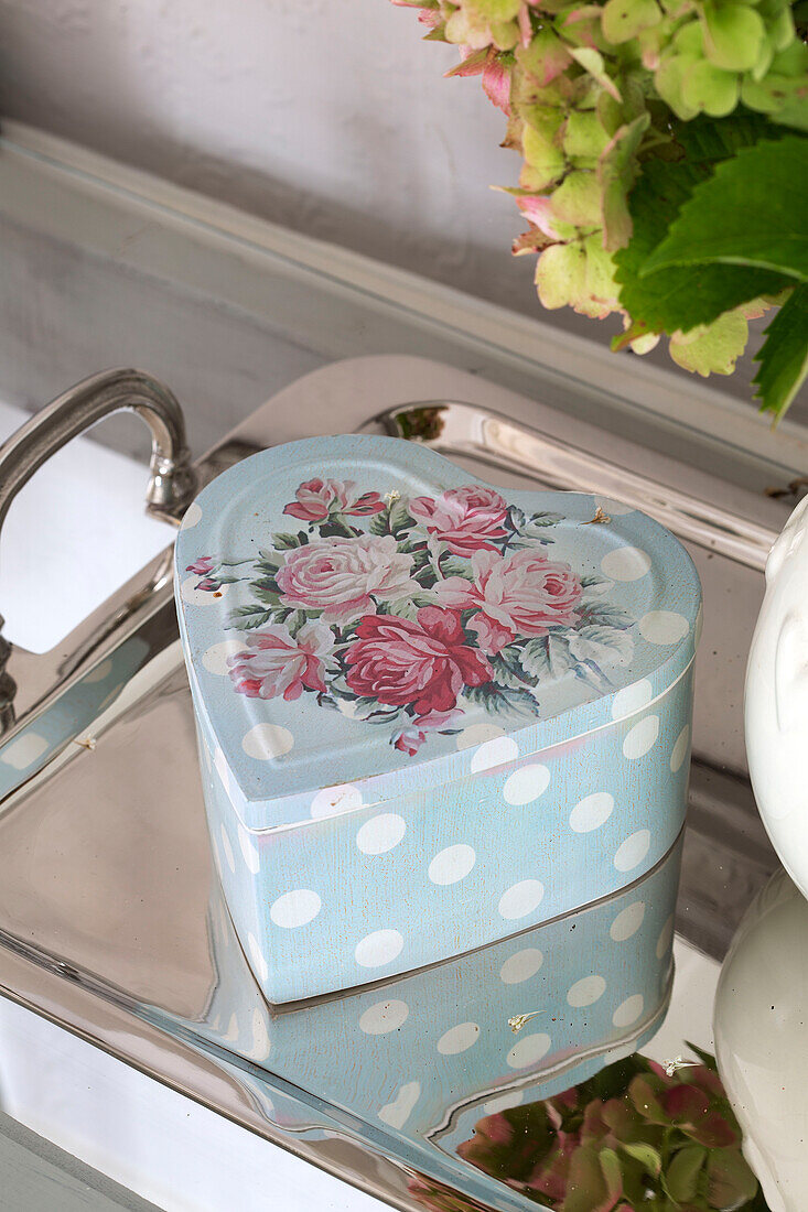 Light blue heart shaped tin on silver tray in UK home