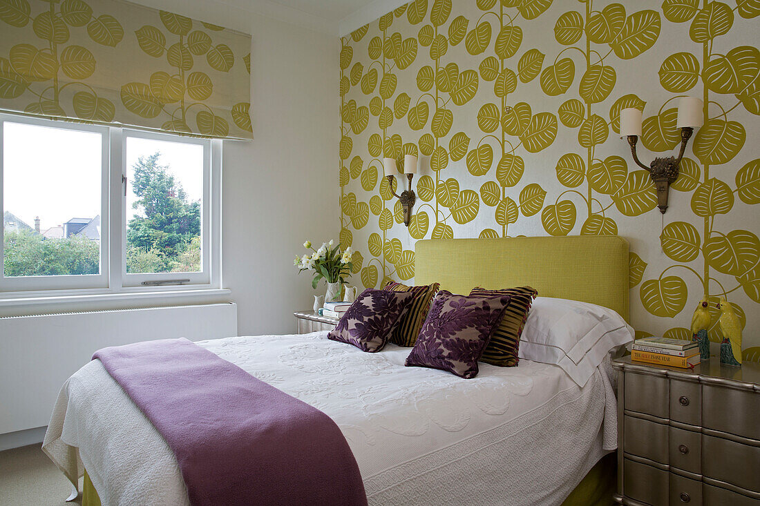 Leaf patterned wallpaper with co-ordinating blinds in double bedroom of UK home