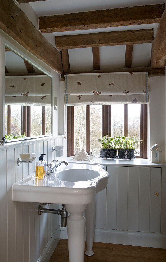 Wash basin and sink in white panelled bathroom of Suffolk farmhouse,  England,  UK