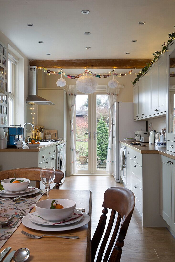 Place setting on dining table in kitchen with fairylights in Dronfield home  Derbyshire  England  UK