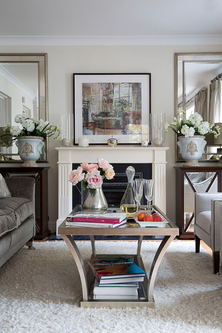 Decanter on glass-topped coffee table in living room of London home   England   UK