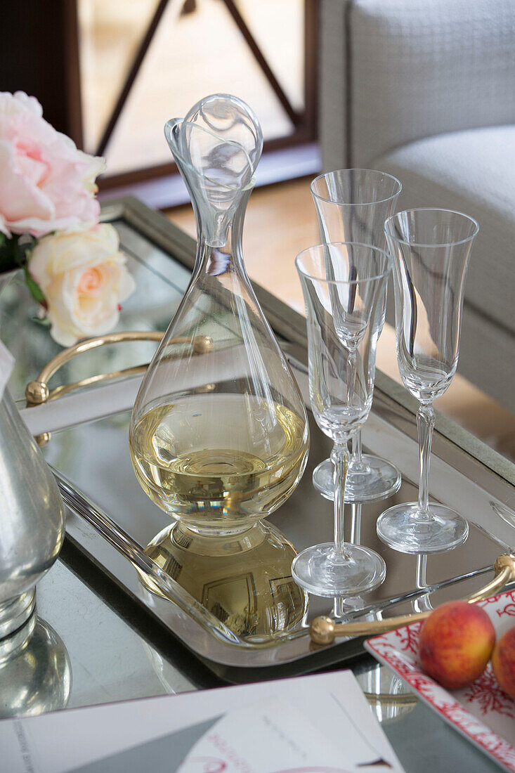 White wine with glasses and decanter on silver tray on coffee table in London home   England   UK